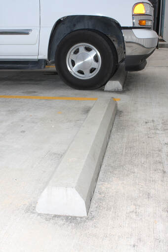 Concrete Wheel Stops in A Parking Lot in Arlington, TX